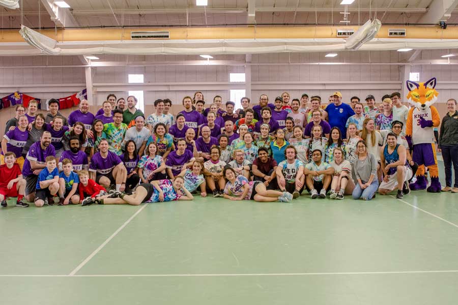 The students, in tye dye, and alumni, in purple, compete in the tournament