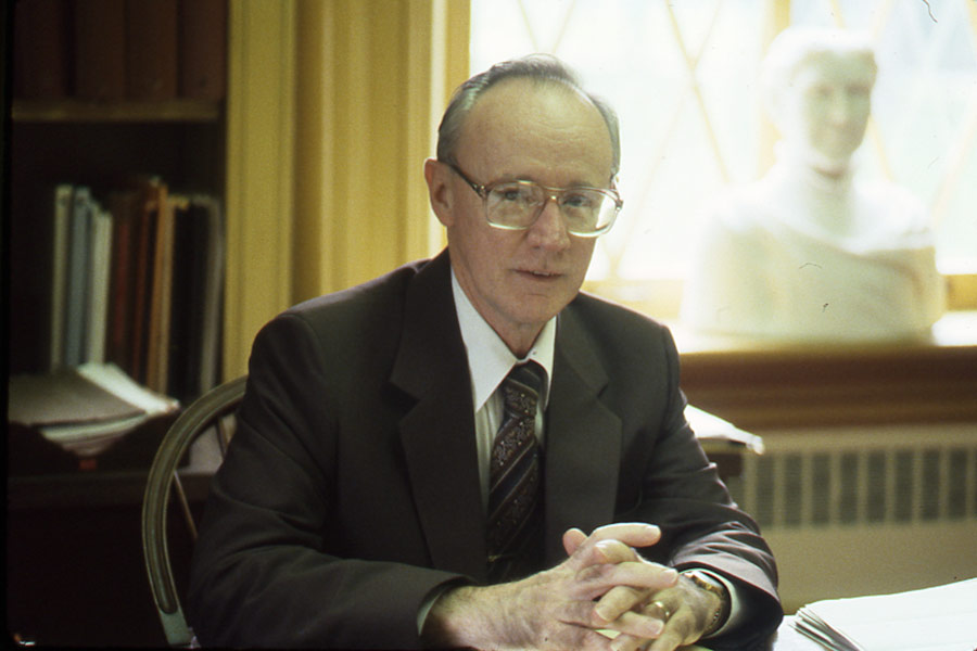John McCall seated at his desk in Old Main.