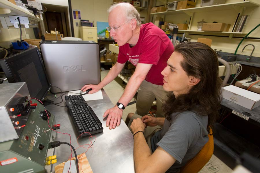 Professor Thomas Moses assists a student with a research project