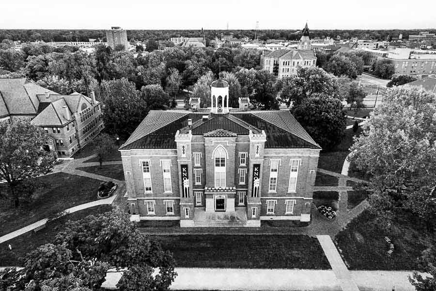 Old Main viewed from above, with the town of Galesburg in the background