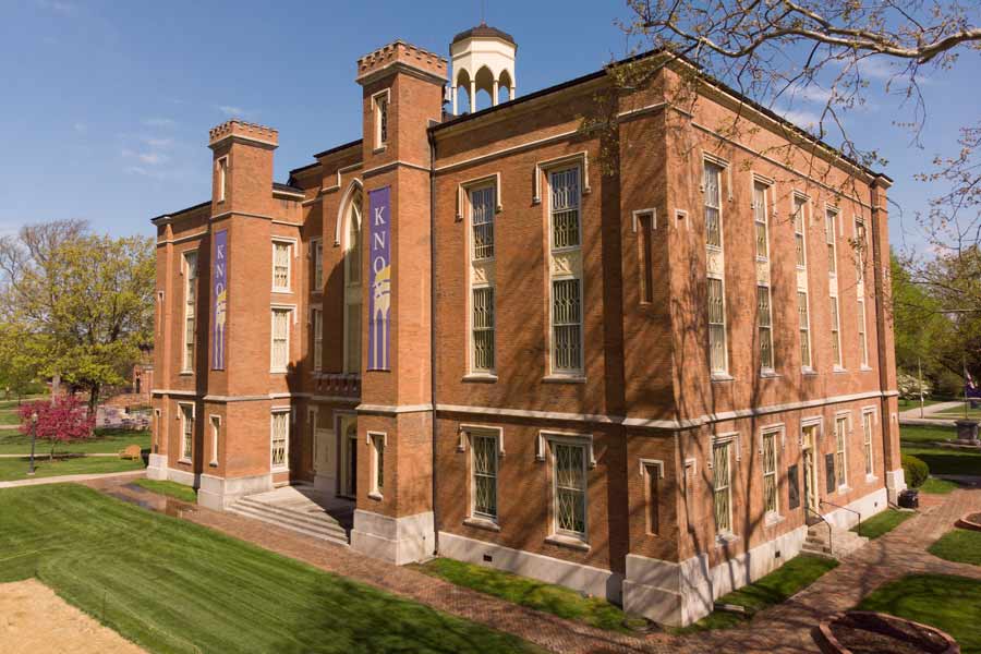 Old Main viewed from above, with the town of Galesburg in the background