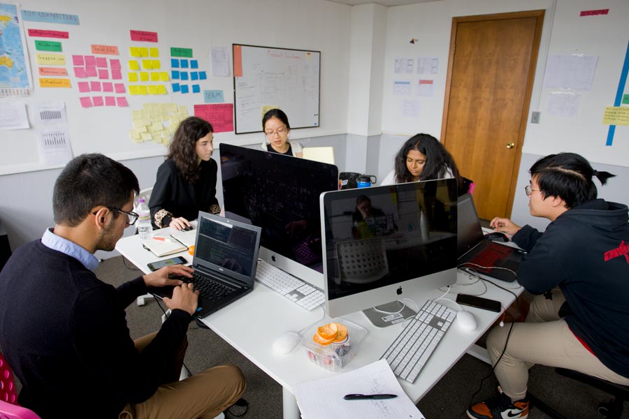 Students working on computers as part of the immersive StartUp Term