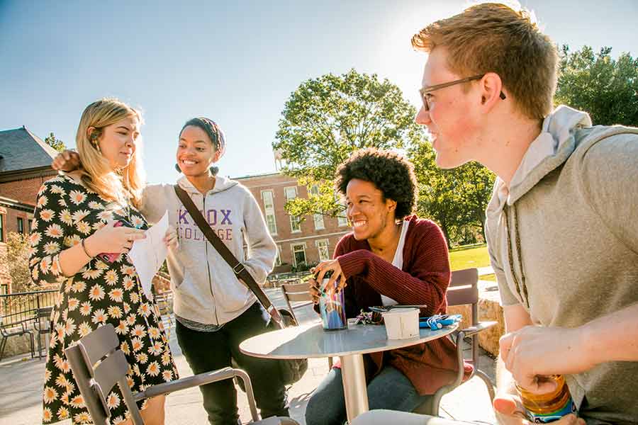 Knox students enjoy a sunny day on a patio. A new report shows Knox and other schools are expanding students' access to education.
