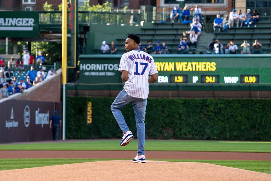 Kyle Williams throws the honorary first pitch of a Cubs-Padres game.