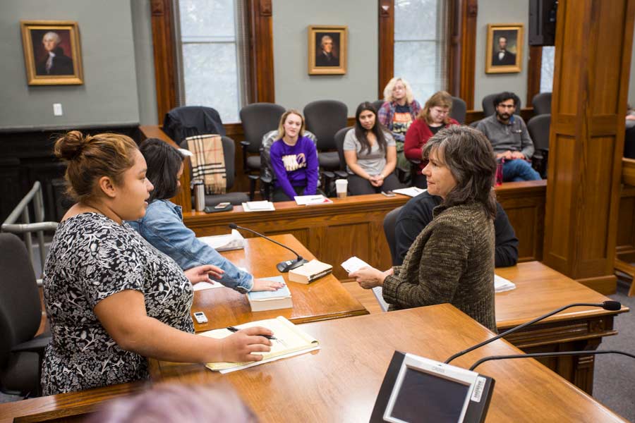 Spanish faculty Robin Ragan talking to students in SPAN 206, Introduction to Spanish Interpretation, during final exam in a courtroom in the Knox County Courthouse, simulating actual legal proceeding, taking roles of interpreter, judge, jury, lawyer, and witnesses.