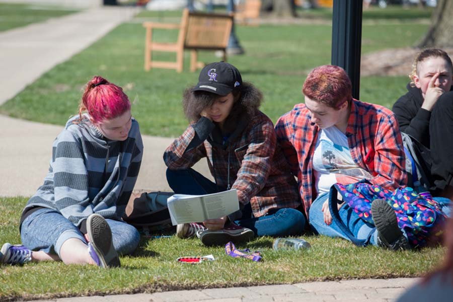 Students on the lawn reading Homer.