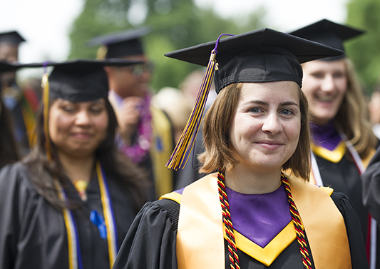 Students embrace during senior pumphandle on the south lawn of Old Main. 