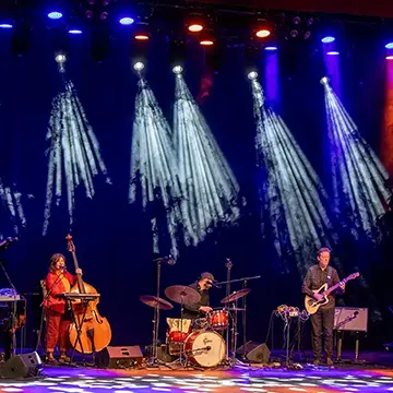 Musicians perform on a stage. 