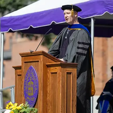 Mark Shroyer stands at a podium and speaks.  
