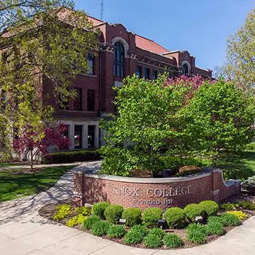 A brick gate is lettered "Knox College," welcoming students and guests to campus.