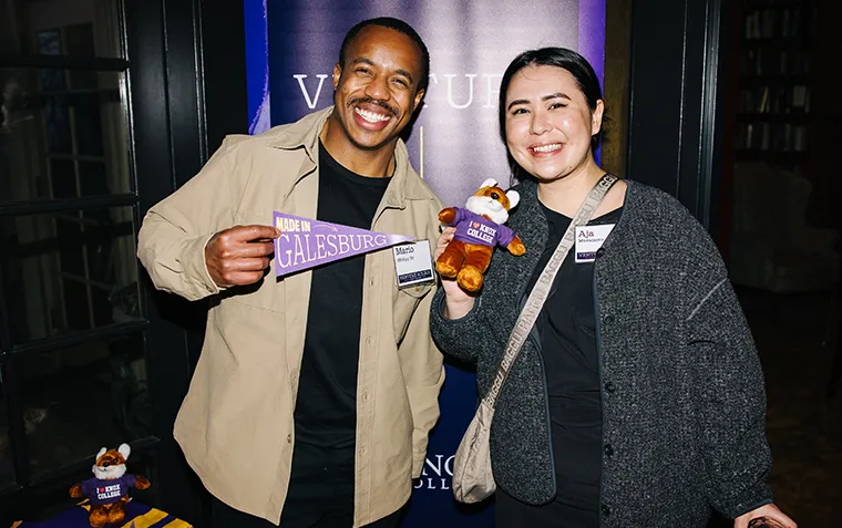 A man and woman smile while showing their Knox swag.