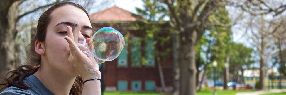 A student blows a bubble at the annual Earth Week Festival