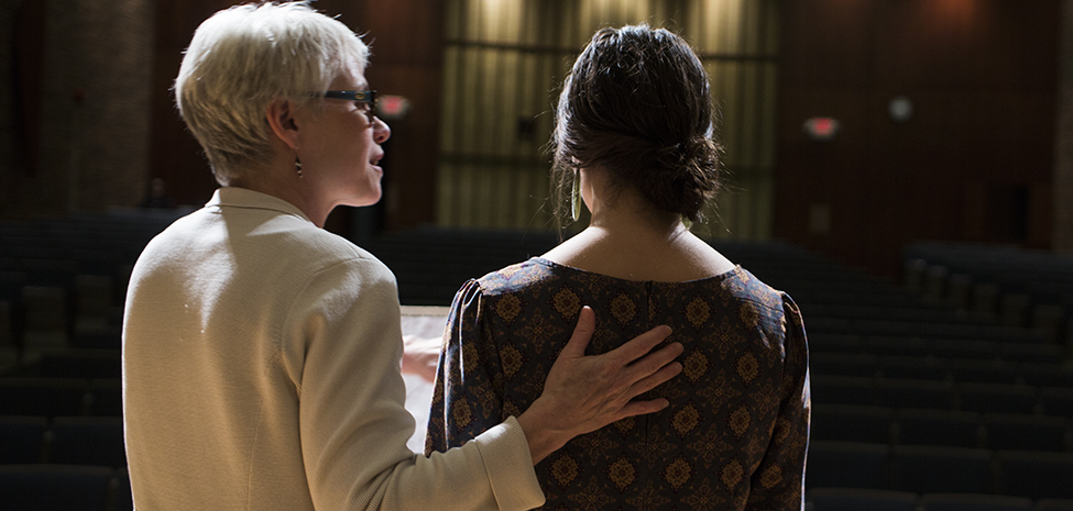 Professor Laura Lane with a student. 