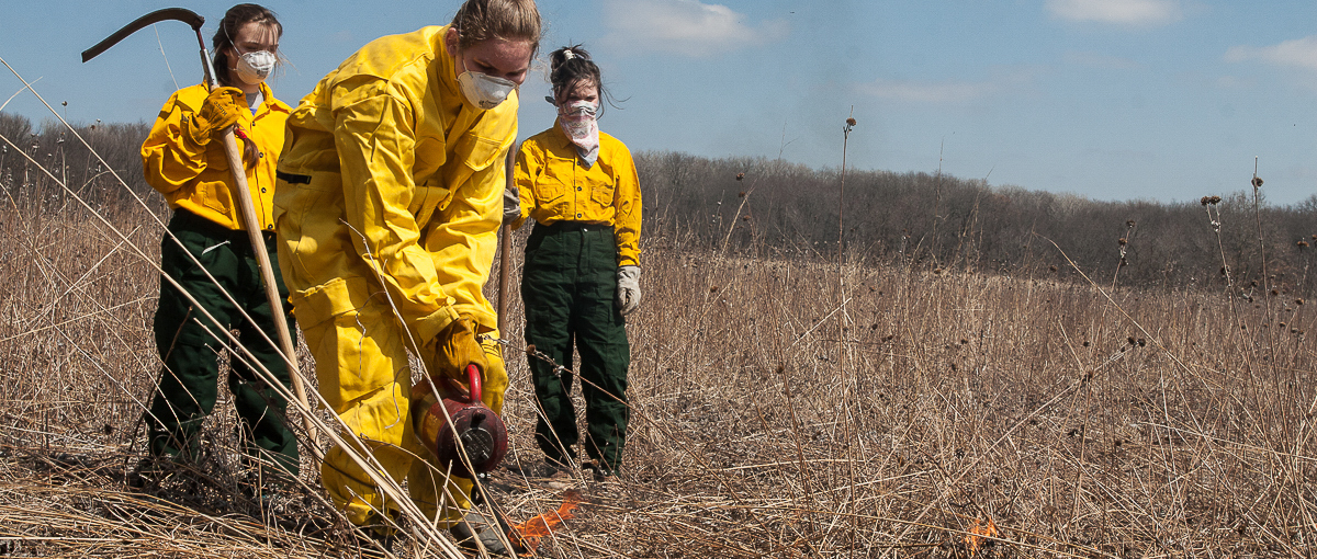 Students conduct a controlled burn at the Green Oaks Biological Field Station. 