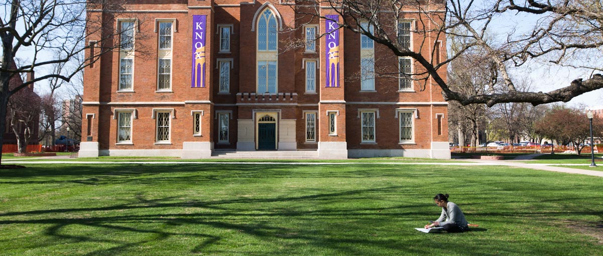 Student in front of Old Main
