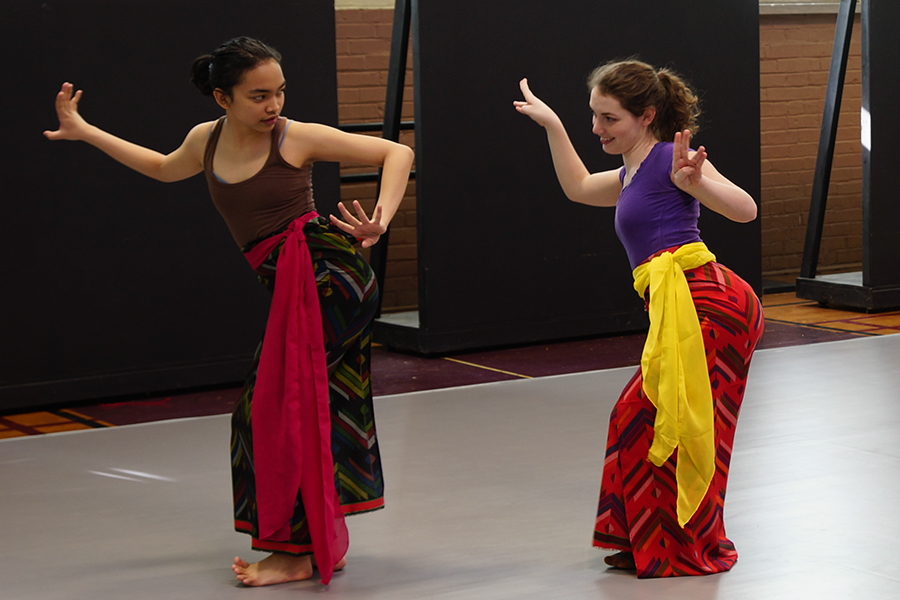 Diandra Soemardi, left, teaches another student a Balinese Dance in the Auxiliary Gym. 