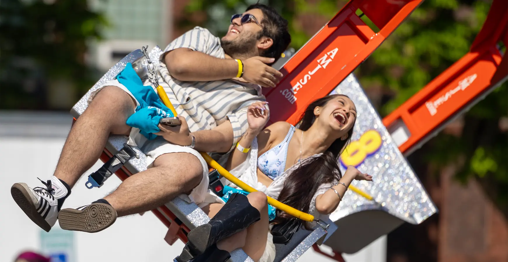 Students on a rollercoaster having fun on Flunk Day.