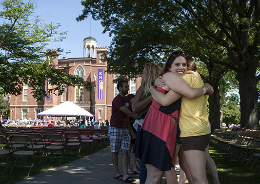 Students embrace during senior Pumphandle at Knox College.